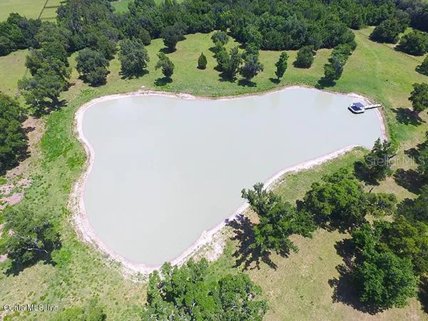 an aerial view of a house with a lake view