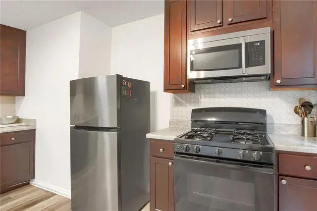 a kitchen with a refrigerator stove and microwave