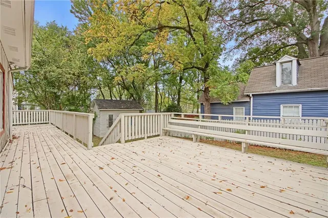 a white house that has a tree in front of it