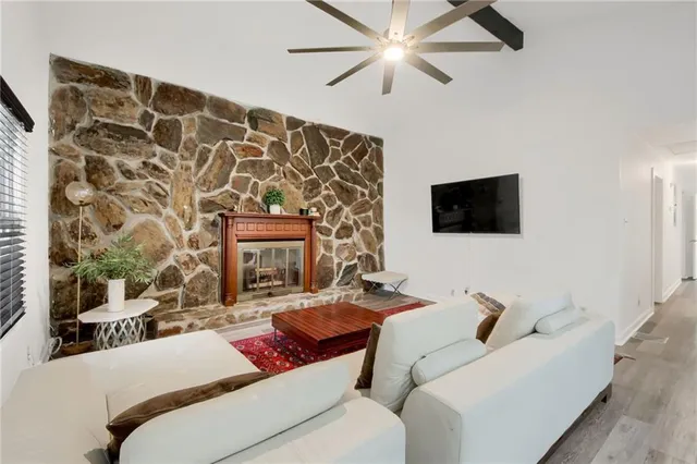 a living room with furniture and a flat screen tv