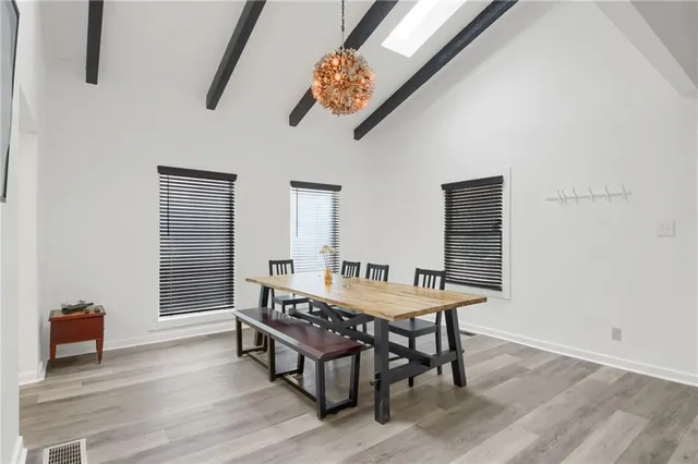a dining room with furniture and wooden floor