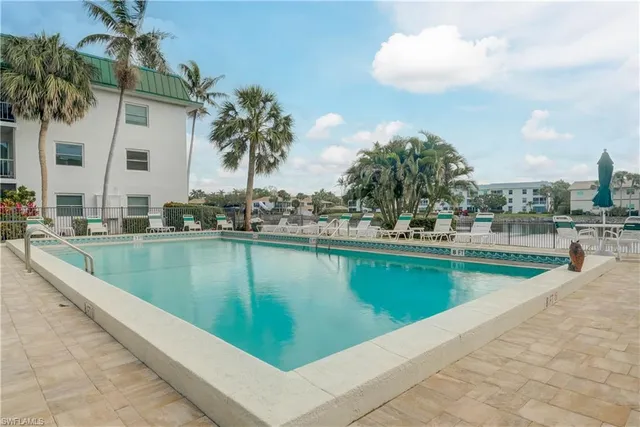 a view of a swimming pool with a lawn chairs