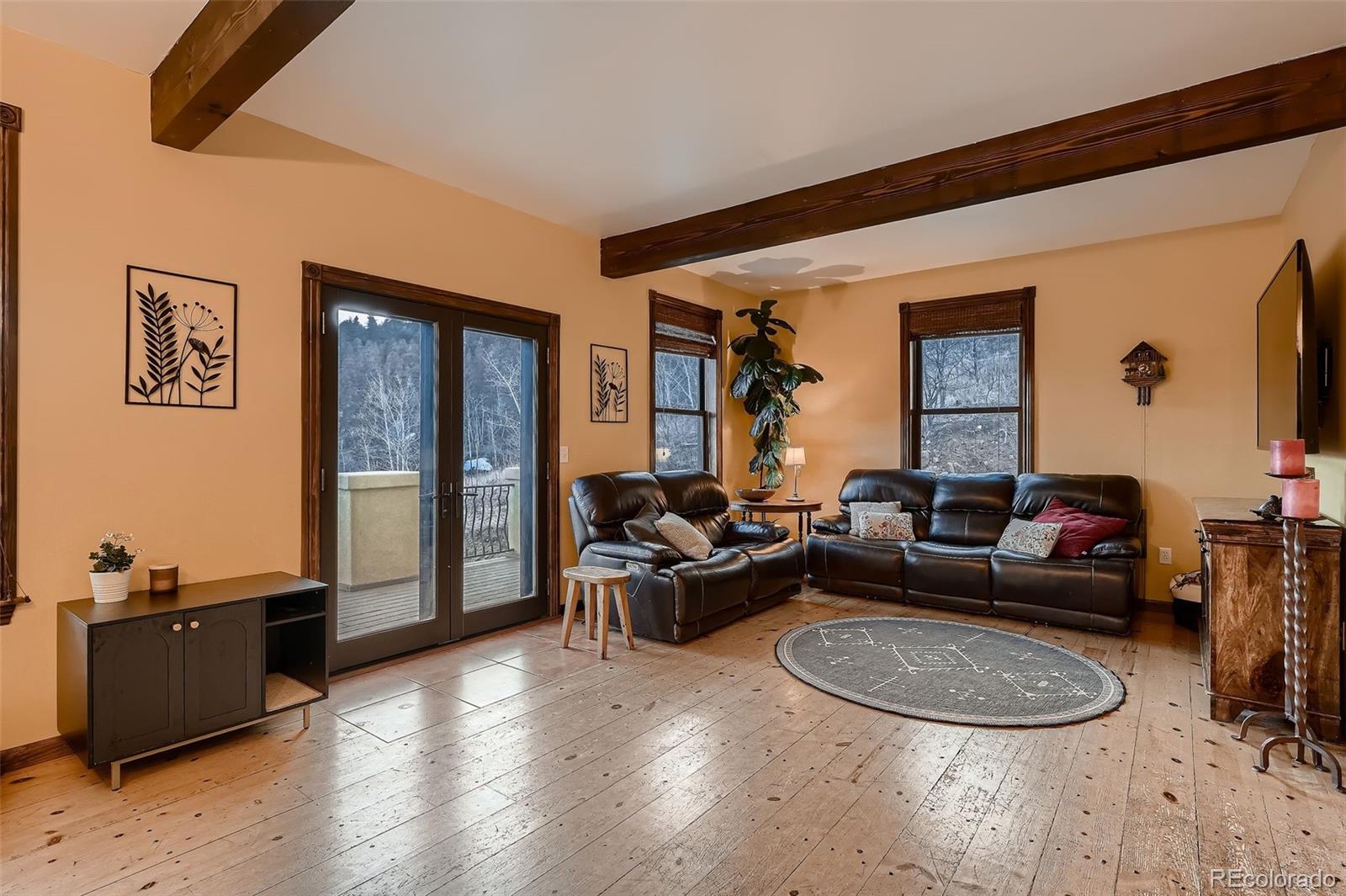 2169 Dory Hill Road Black Hawk, CO 80422 - Photo 11 of 46 a living room with furniture and a wooden floor