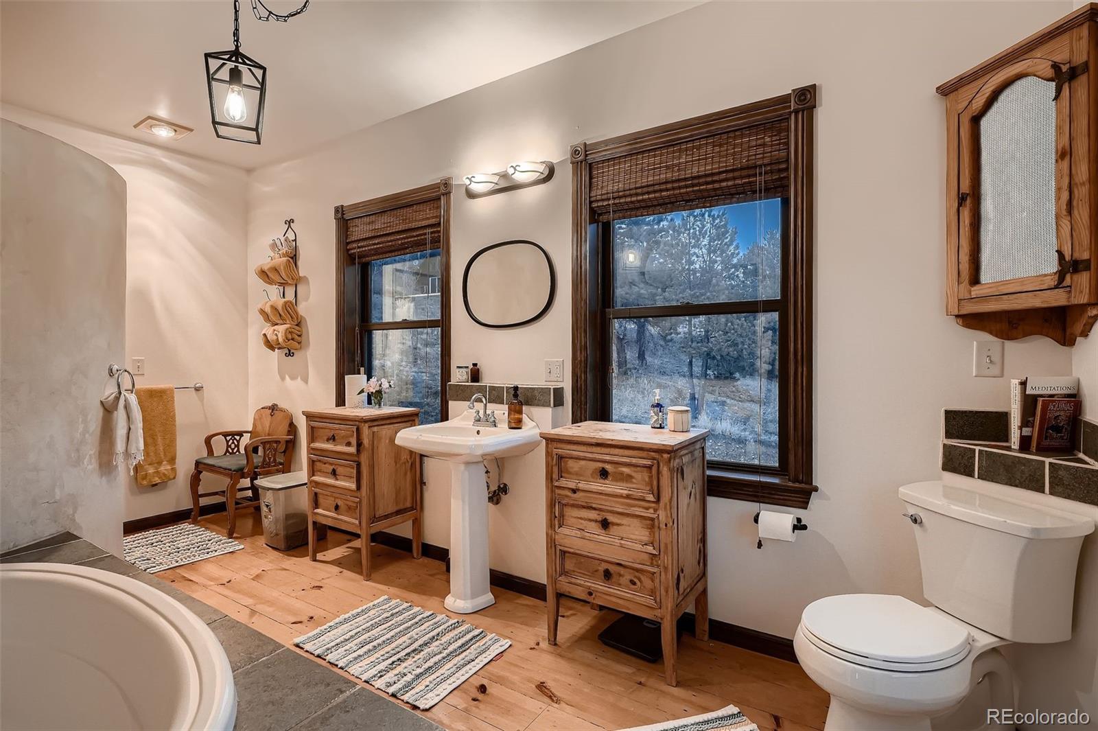 2169 Dory Hill Road Black Hawk, CO 80422 - Photo 17 of 46 a bathroom with a toilet a sink and a mirror