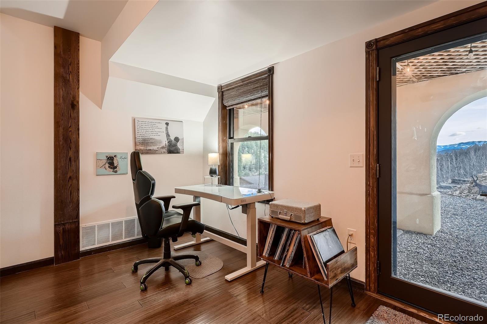 2169 Dory Hill Road Black Hawk, CO 80422 - Photo 25 of 46 a view of a workspace room with wooden floor and windows