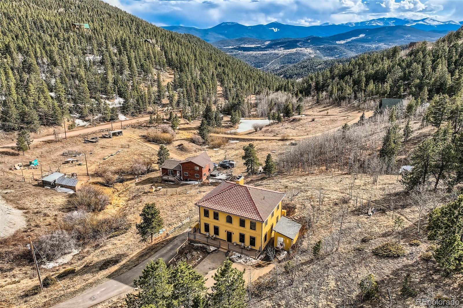 2169 Dory Hill Road Black Hawk, CO 80422 - Photo 38 of 46 a view of a large building in the middle of a yard