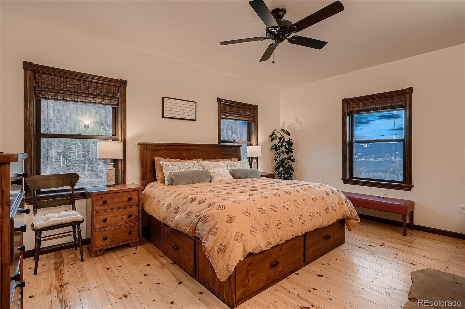 2169 Dory Hill Road Black Hawk, CO 80422 - Photo 5 of 46 a bedroom with a bed and a chandelier