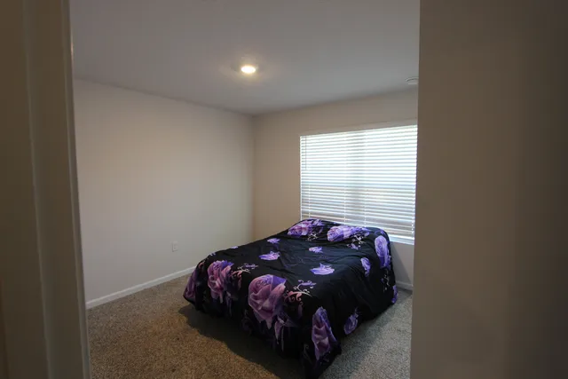 a bedroom with a bed and window