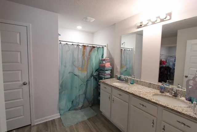a bathroom with a double vanity sink and mirror