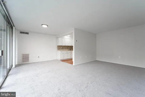 a view of an empty room with a window