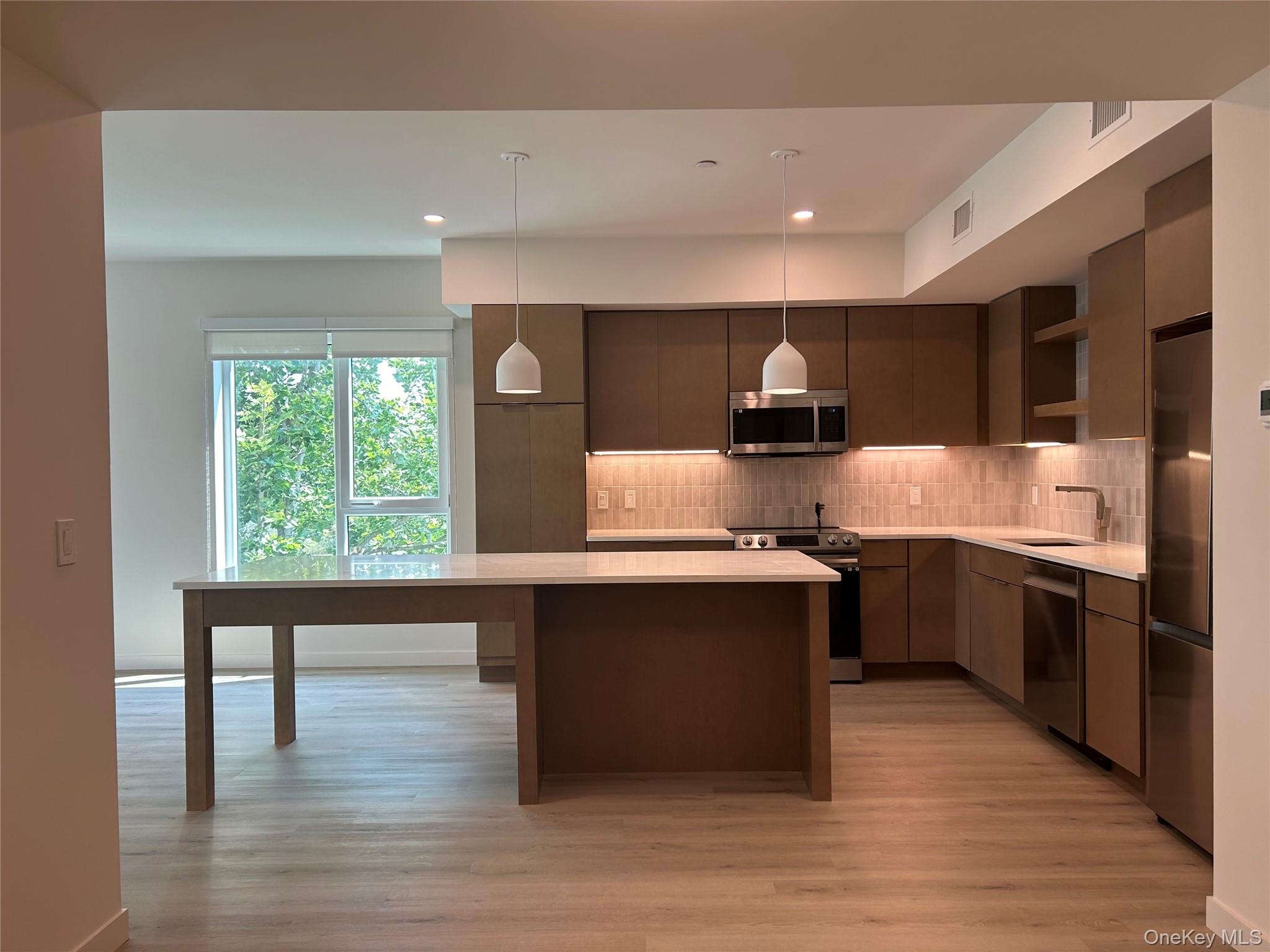 44 Springside Avenue, Unit 4F Poughkeepsie, NY 12603 - Photo 1 of 1 a large kitchen with stainless steel appliances granite countertop a stove and a wooden floors