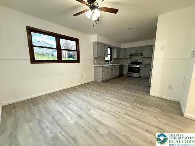 a view of a kitchen with furniture and windows