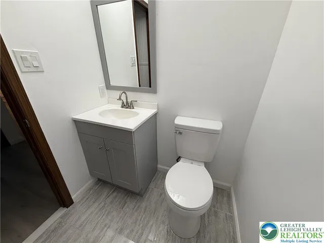 a white toilet sitting next to a bathroom sink
