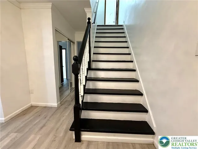 a view of entryway and hall with wooden floor