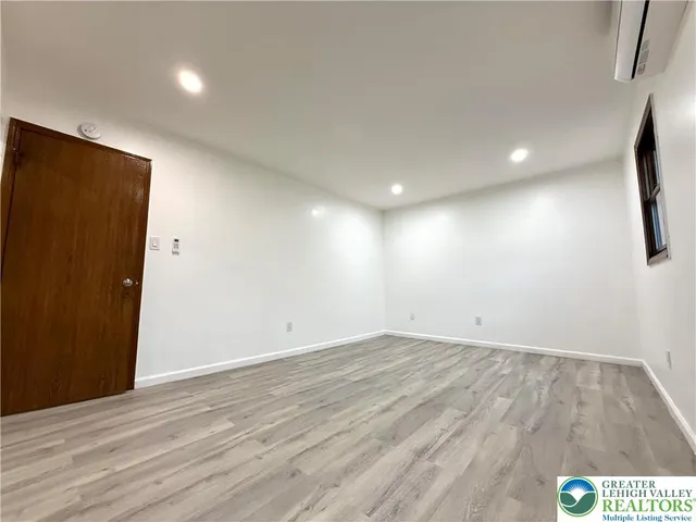 an empty room with wooden floor and closet