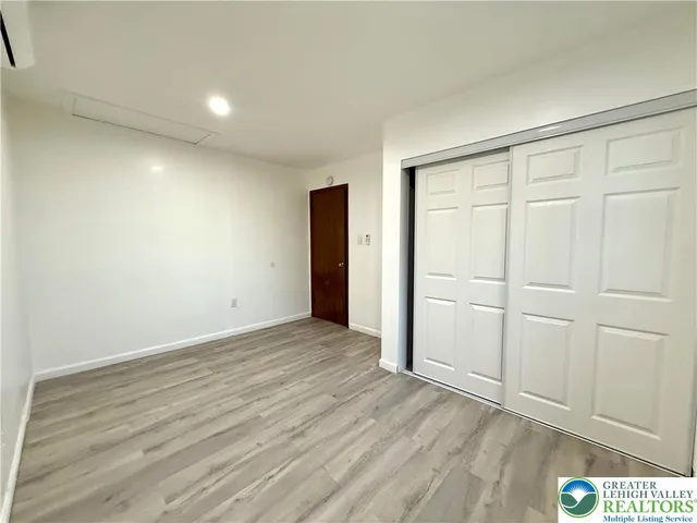 a view of an empty room and wooden floor