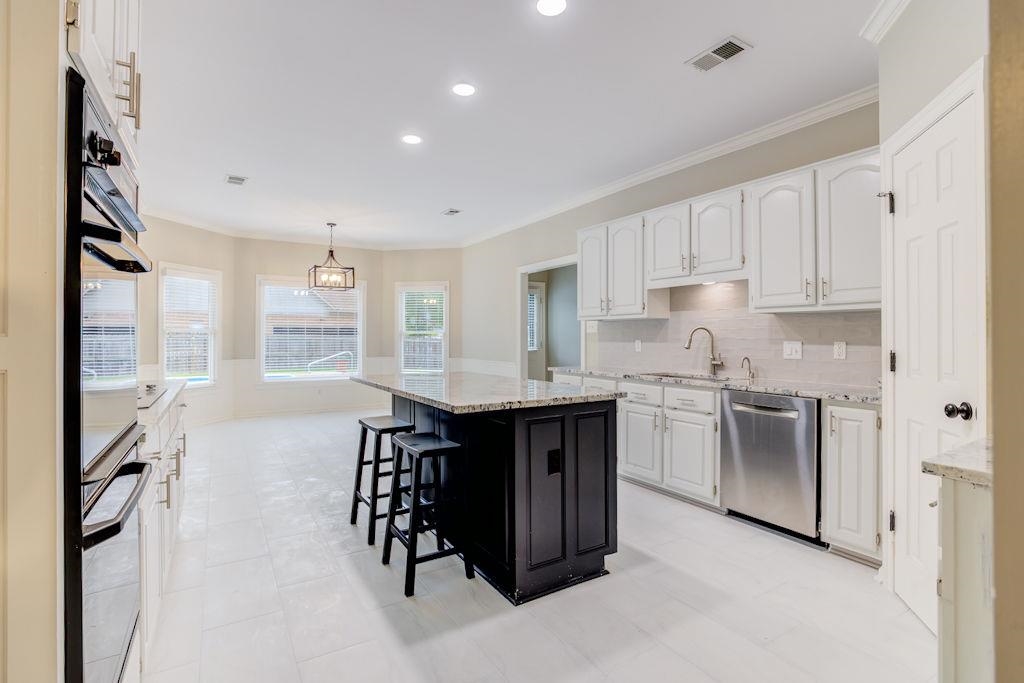 1633 Beckenhall Street Collierville, TN 38017 - Photo 1 of 35 a kitchen with a sink stove and cabinets