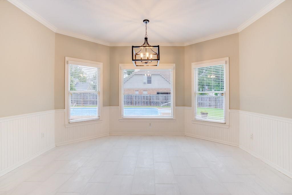 1633 Beckenhall Street Collierville, TN 38017 - Photo 13 of 35 an empty room with windows and chandelier