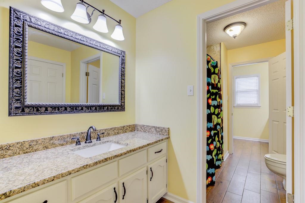 1633 Beckenhall Street Collierville, TN 38017 - Photo 21 of 35 a bathroom with a granite countertop sink and a mirror