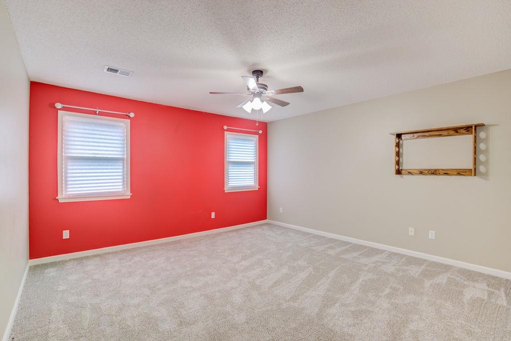 1633 Beckenhall Street Collierville, TN 38017 - Photo 22 of 35 an empty room with windows and chandelier fan