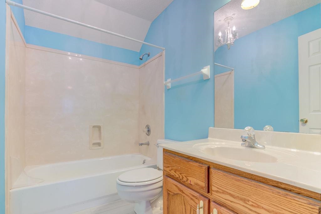 1633 Beckenhall Street Collierville, TN 38017 - Photo 24 of 35 a bathroom with a sink a toilet a mirror a bathtub and shower