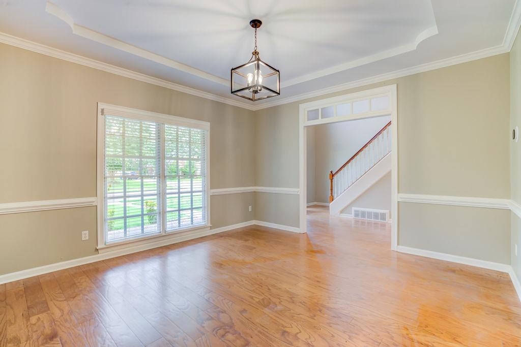 1633 Beckenhall Street Collierville, TN 38017 - Photo 5 of 35 wooden floor in an empty room with a window