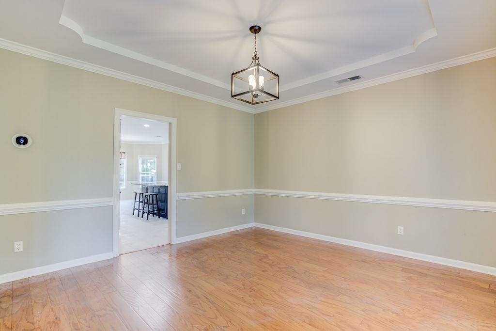 1633 Beckenhall Street Collierville, TN 38017 - Photo 6 of 35 wooden floor in an empty room with a window