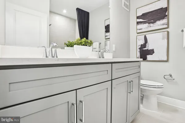 a bed room with a bed and painting on the wall