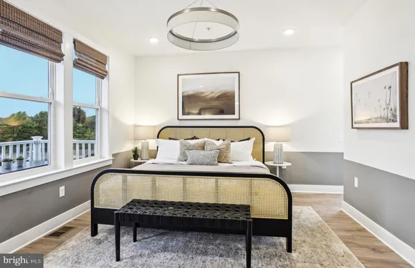 a bedroom with a bed and painting on the wall