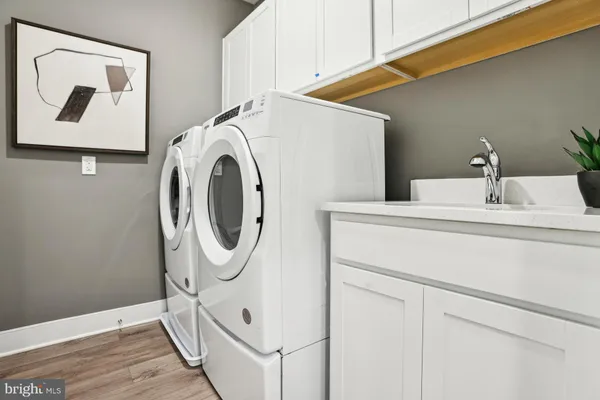 a bathroom with a shower sink and mirror