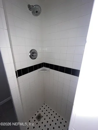 a bathroom with a shower and a sink
