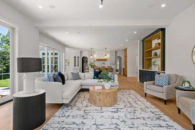 a living room with furniture a large window and a fireplace