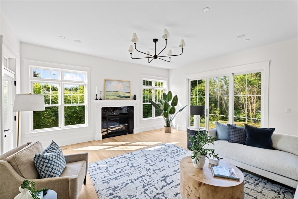 16 Foley Beach Road Hingham, MA 02043 - Photo 15 of 34 a living room with furniture a large window and a fireplace