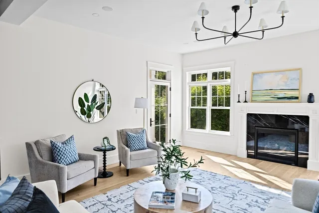 a view of a dining room with furniture and a chandelier