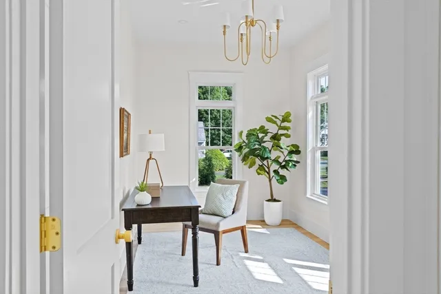 a living room with furniture and a chandelier