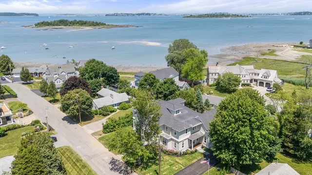 an aerial view of a houses with ocean view