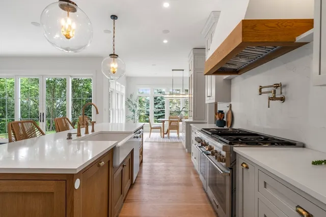 a view of a dining room with furniture and large windows