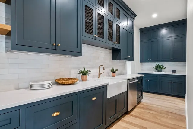 a large kitchen with sink a counter top space and living room view