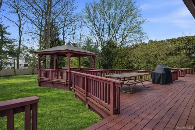 a view of a house with a big yard and large trees