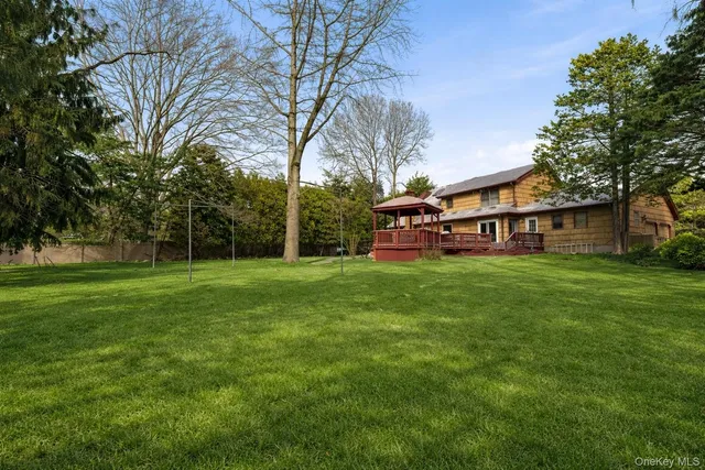 an aerial view of residential house with outdoor space and trees all around