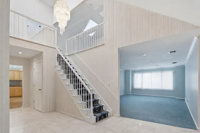 a view of staircase with white walls and windows