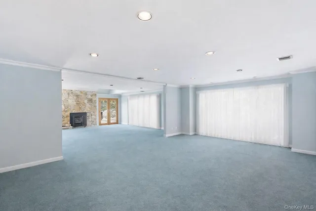 a view of empty room with a fireplace