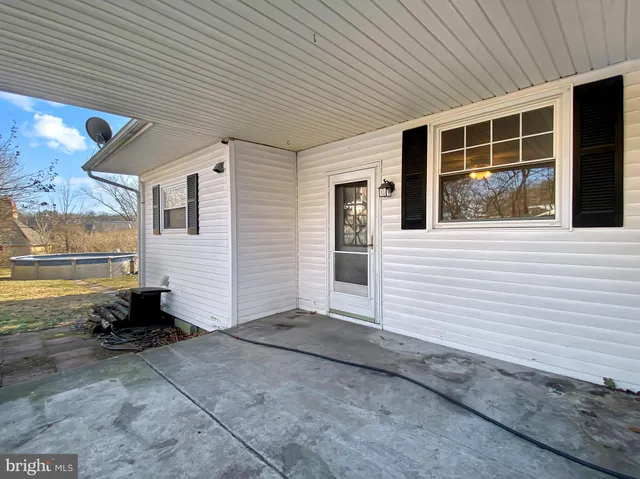 a view of a yard with wooden fence