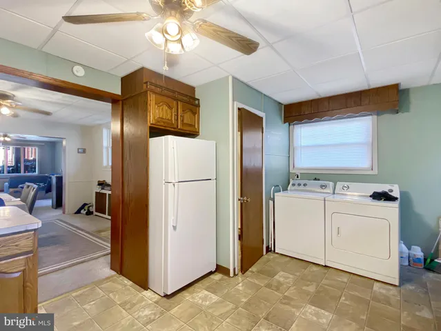 a kitchen with refrigerator a stove a sink dishwasher and cabinets with wooden floor