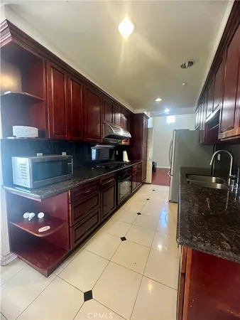 a kitchen with stainless steel appliances granite countertop a sink and cabinets