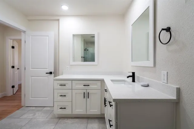 a bathroom with a sink vanity and a mirror
