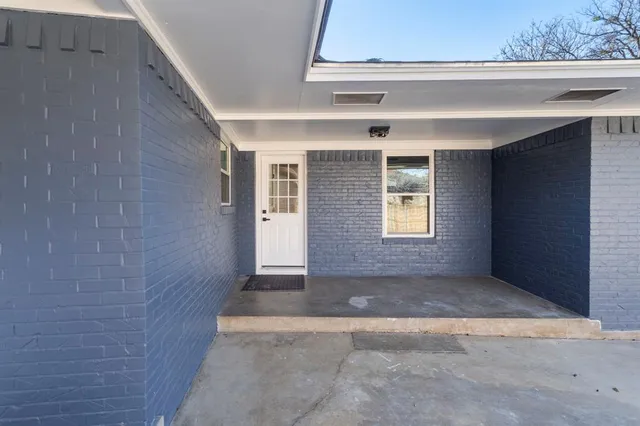 a view of a brick house with a large window