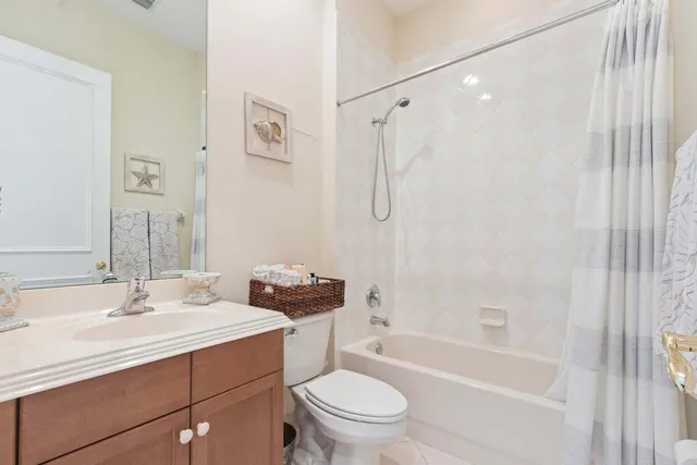 a bathroom with a sink toilet vanity and shower