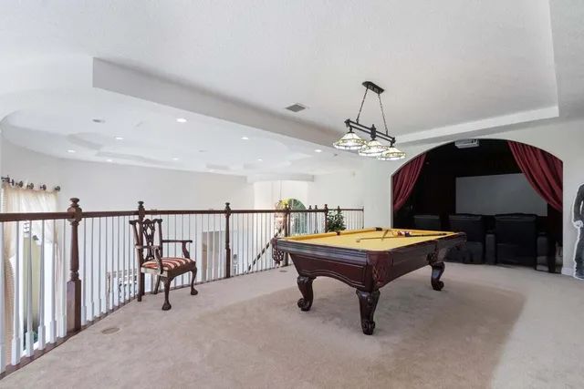 a room with pool table and furniture