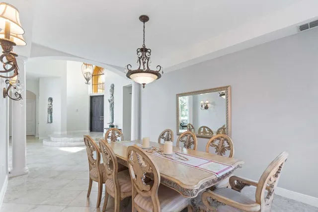 a view of a dining room with furniture wooden floor and chandelier